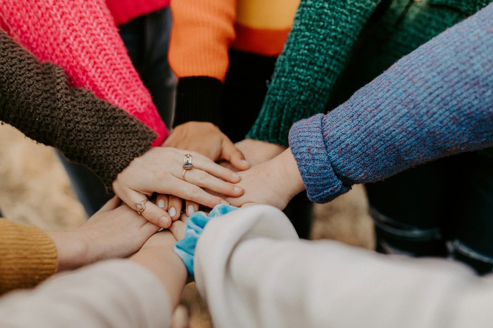 Diverse team stacking hands in collaboration
